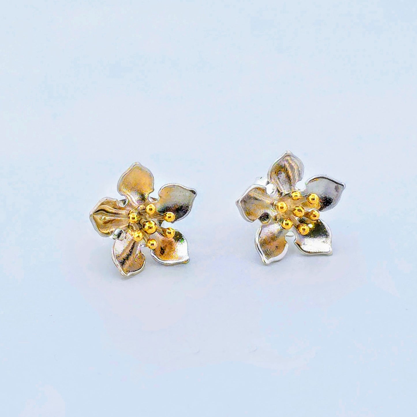 Flower earrings with red gold pins.
